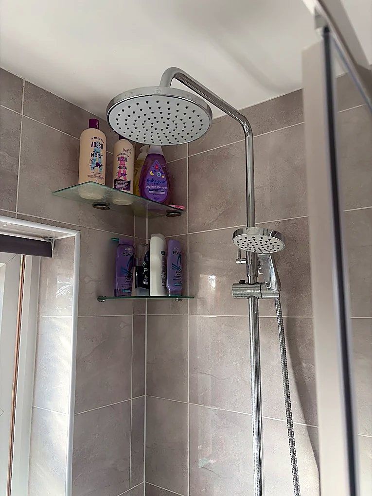 Chrome rainfall and handheld shower fitted over tiling
